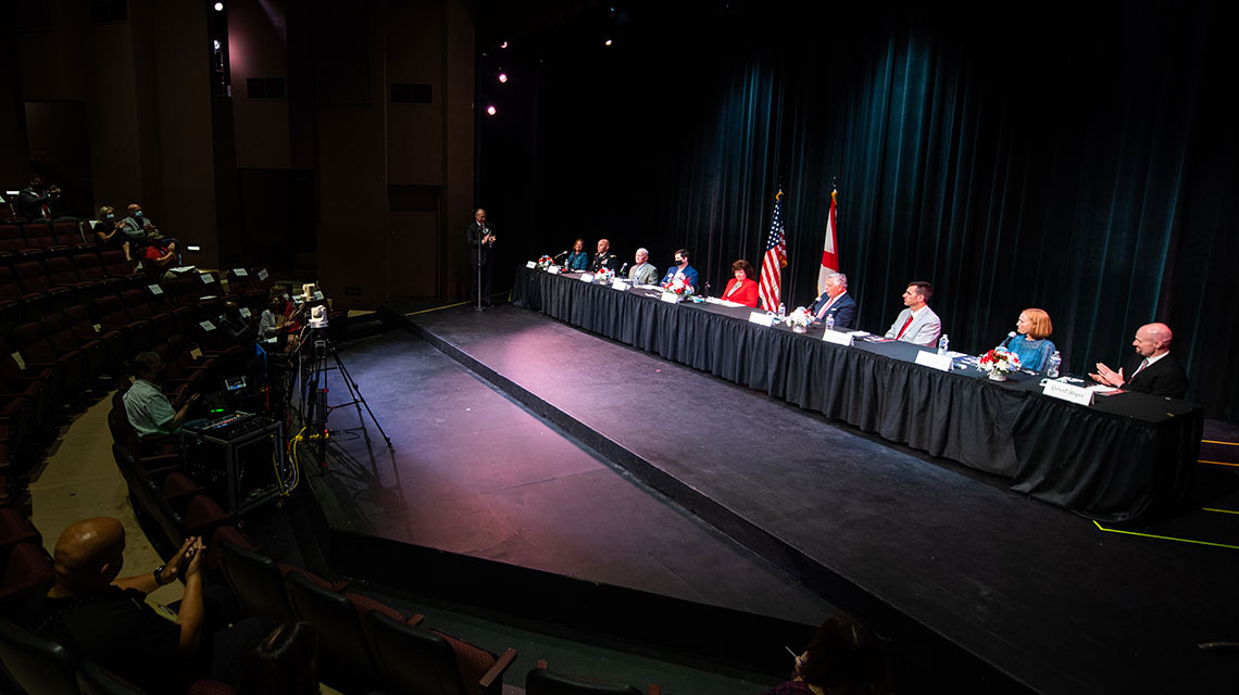 Panelists from the September 11 Rememberance event are seated on the state in the Stone Center.